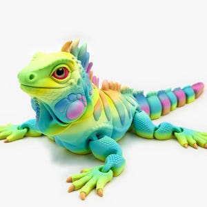 May include: An articulated iguana figurine featuring a vibrant rainbow gradient of yellow, blue, pink, and green. The lizard has a textured, scaly surface, a prominent crest along its back, and a long, segmented tail that curves slightly to the side.