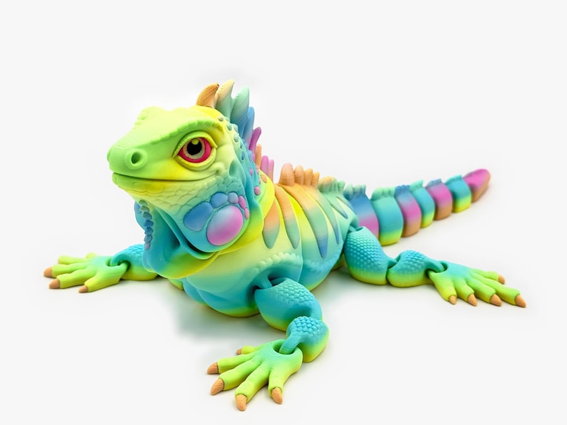 May include: An articulated iguana figurine featuring a vibrant rainbow gradient of yellow, blue, pink, and green. The lizard has a textured, scaly surface, a prominent crest along its back, and a long, segmented tail that curves slightly to the side.