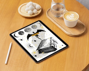 May include: A digital tablet displaying a black and white illustration of a dragon flying with a book underneath it. The illustration is on a white background with a pattern of stars and moons. The tablet is on a wooden table with a cup of coffee and a plate of white chocolate truffles.