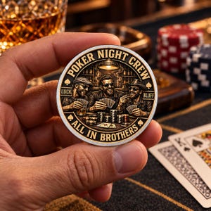May include: A circular metal coin featuring an engraved illustration of three individuals playing poker at a table. The text POKER NIGHT CREW, LUCK, BLUFF, and ALL IN BROTHERS is inscribed around the border. The design includes stacks of chips.