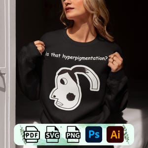May include: A black sweatshirt with a white graphic of a cartoon face and the text "is that hyperpigmentation?"  The graphic is a simple line drawing of a face with a large eye and a black dot on the cheek.  The sweatshirt is shown being worn by a person.