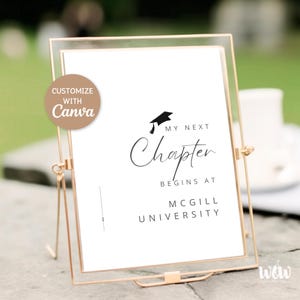 May include: A white printable sign with black text that reads "My next chapter begins at McGill University". A black graduation cap icon is above the text. The sign is in a gold frame and is sitting on a table.
