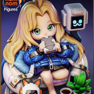 May include: A chibi-style figurine featuring a character with long blonde hair and green eyes, wearing a blue puffer jacket. The character sits in a futuristic chair with a small robot, a potted green plant, and a cup of coffee nearby.