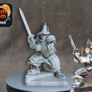May include: A gray figurine of a knight in full armor, holding a sword in a defensive stance. The knight is standing on a stone base. A smaller, colored version of the knight is also present. The logo for "nom nom Figures" is in the upper left corner.