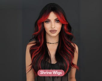 May include: A black wig with red highlights and long, wavy layers. The wig features a dark root with bright red streaks framing the face. The image includes the text "Shrine Wigs" at the bottom.