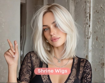 May include: A woman with light blonde hair styled in a shoulder-length bob. She wears a black lace top and a silver necklace. The image includes the text "Shrine Wigs".