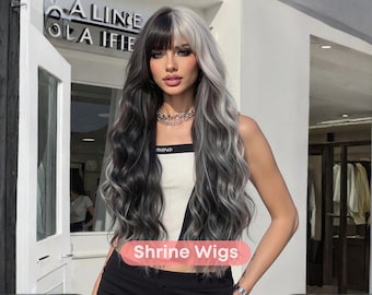 May include: A long, wavy wig with a split color design. One side is black, the other is silver-gray. The wig has a fringe and is styled with loose curls. The text "Shrine Wigs" is visible.
