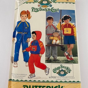 May include: A vintage sewing pattern for Cabbage Patch Kids clothing. The pattern is for size 6 and includes iron-on transfers. The pattern features illustrations of children wearing the clothing.