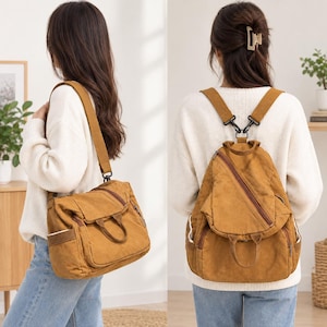 Può includere: Una borsa convertibile in tela color giallo senape dotata di manico superiore, scomparti multipli con cerniera e spallacci regolabili che consentono di indossarla come borsa a tracolla o zaino. Include tasche laterali e metallo.