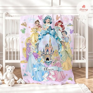 May include: A light purple fleece blanket featuring a central illustration of a castle surrounded by various animated princesses in colorful gowns, with balloons, fireworks, and a blue ribbon banner displaying the name Olivia in black script.