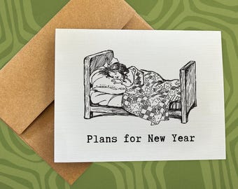 May include: A black and white illustration on a white card shows a person sleeping in a bed, covered by a patterned quilt. The text "Plans for New Year" is printed below the image. The card is paired with a brown envelope.