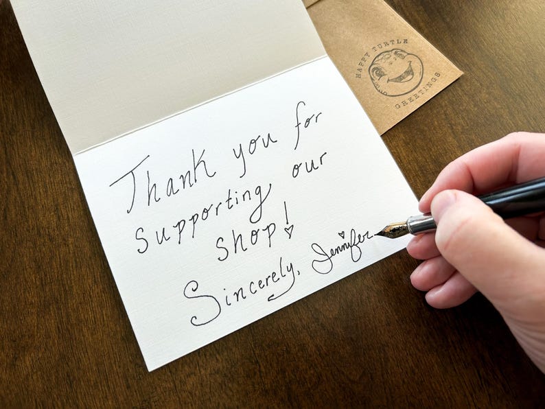 May include: A handwritten thank you note on a white card with the text "Thank you for supporting our shop! Sincerely, Jennifer".