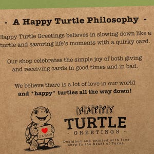 May include: A brown paper card with the text "A Happy Turtle Philosophy" and a drawing of a turtle holding a card that says "CARDS". The text below the drawing says "HAPPY TURTLE - GREETINGS - Designed and printed with love deep in the heart of Texas."