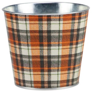 May include: A small metal planter with a plaid pattern in orange, black, white, and green.