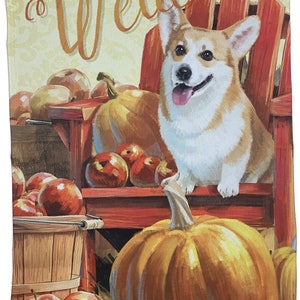 May include: A welcome garden flag with a corgi dog sitting on a red wooden chair with pumpkins and apples. The flag has a yellow background with the word "Welcome" in a cursive font.