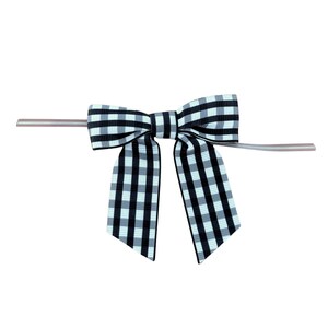 May include: A black and white checkered bow with a silver wire attached.