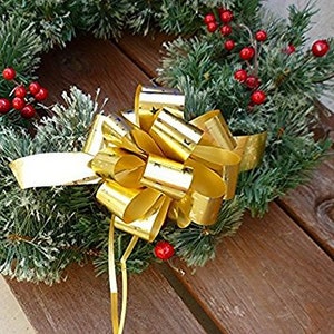 May include: A gold metallic bow with a star pattern, perfect for adding a festive touch to gifts or wreaths.
