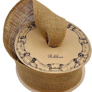 May include: A roll of natural brown burlap ribbon with a decorative paper spool. The spool has a vintage design with the word "Ribbon" printed on it.