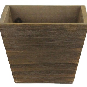 May include: A rustic, square wooden planter with a tapered design. The planter is constructed from weathered, brown-toned wood, showcasing visible grain and texture. The interior is a lighter shade of brown. Ideal for indoor or outdoor use.