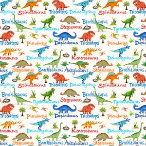 May include: A repeating pattern of various colorful dinosaurs, including Triceratops, Spinosaurus, and Tyrannosaurus, on a cream-colored background. The dinosaurs are in shades of green, orange, blue, and red, with their names written in a playful font.