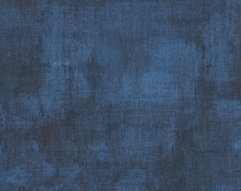 May include: A solid piece of fabric featuring a deep navy blue color with a mottled, distressed texture. The surface displays a woven appearance with darker charcoal and black patches layered over the blue, creating a weathered, uneven visual effect.