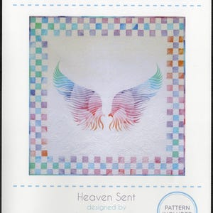 May include: A quilt pattern titled "Heaven Sent" with a design of angel wings in shades of pink, blue, and green. The pattern includes a checkered border in pastel colors. The text "Hoffman Sew into it!" is at the top.