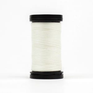 May include: A spool of white thread with a black plastic top and bottom.