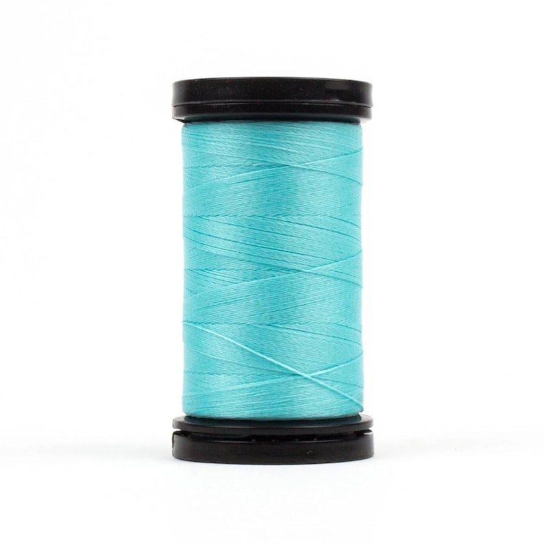 May include: A spool of turquoise blue thread wound on a black plastic bobbin.