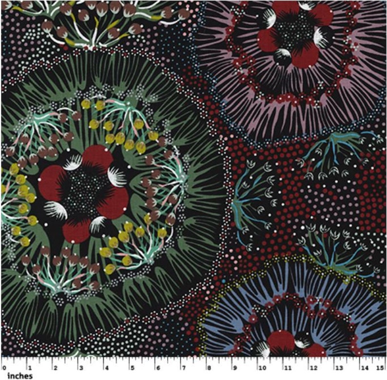 May include: A fabric with a repeating floral pattern in shades of red, green, yellow, and white on a black background. The design features circular floral motifs with intricate details, including dotted accents and leaf-like shapes. The image includes a ruler with inches.