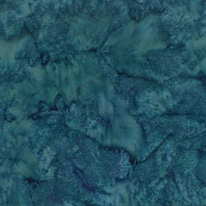 May include: A close-up of a fabric with a batik design. The fabric features shades of teal and blue, with a marbled, organic pattern. The design has a watercolor effect, with areas of lighter and darker tones.