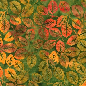 May include: A green fabric with a repeating pattern of orange, yellow, and red leaves. The leaves are stylized and have a batik-like appearance.