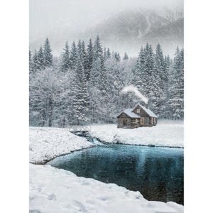 May include: A serene winter landscape featuring a snow-covered cabin nestled among snow-laden evergreen trees. A small bridge crosses a stream that flows into a dark blue lake. Smoke rises from the cabin's chimney, suggesting warmth.