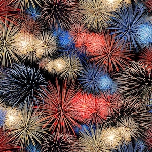 May include: A fabric pattern featuring a dense, repeating display of fireworks against a solid black background. The design showcases bursts of light in vibrant shades of red, bright blue, and shimmering gold, creating a festive visual effect.