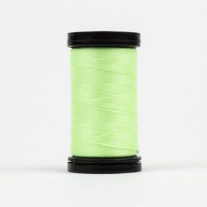 May include: A spool of light green thread with black plastic caps on either end.