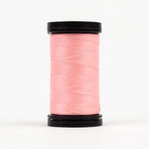 May include: A spool of pink thread with black plastic ends.