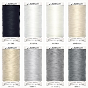 May include: Eight spools of Gütermann sewing thread arranged in two rows. Each spool features a white label with the brand name, a length of 250 m - 274 yds/vgs, and a color name and number including black, white, oyster, eggshell, bone, silver, mist grey, and slate.