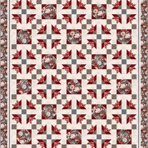 Puede incluir: Una colcha con un patrón rojo, blanco y gris. La colcha está hecha de cuadrados con un diseño floral en el centro de cada cuadrado. La colcha está rodeada por un borde de tela floral.