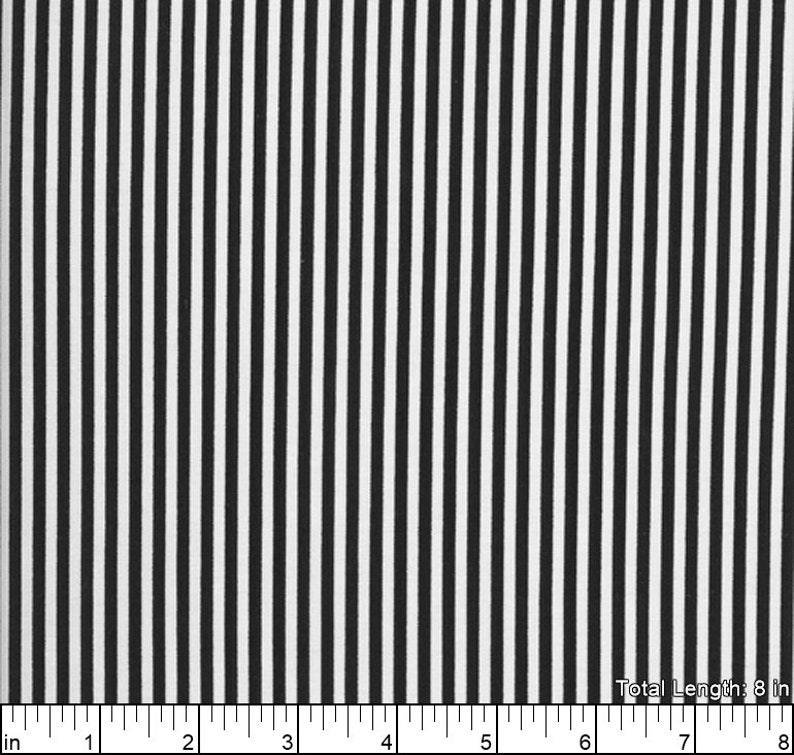 May include: Black and white striped fabric with a repeating pattern. The fabric is 8 inches long.