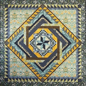 May include: A quilt with a geometric pattern in shades of blue, green, yellow, and brown. The center of the quilt features a star shape.