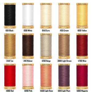 May include: A selection of Gütermann thread spools in a range of colours: black, white, ecru, cream, yellow, tan, walnut, beige, light brown, wine, red, pink, light rose, light plum, and magenta. Each spool has a colour code and contains 250 metres (274 yards) of thread.