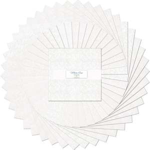 May include: A circular arrangement of white fabric squares, each with a subtle floral pattern. The center square features the text "White Out". The squares are neatly stacked, creating a visually appealing display for quilting or crafting projects.