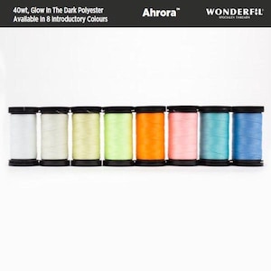 May include: Eight spools of 40wt glow-in-the-dark polyester thread in various colours, including white, light green, yellow, orange, pink, blue, and light blue. The spools are labelled "Ahrora™ WONDERFIL SPECIALTY THREADS".