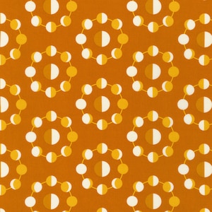 May include: An orange fabric with a repeating pattern of circular designs. Each circle is composed of smaller white and yellow circles connected by thin yellow lines. The center of each circle features a half-moon shape in a darker orange.
