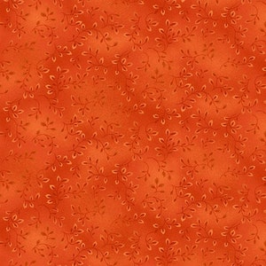May include: Orange fabric with a repeating pattern of delicate, light brown vines and leaves. The fabric has a mottled appearance, with variations in the orange hue, creating a textured look. The design is suitable for quilting or crafting projects.