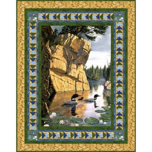 May include: A painting depicting a lake scene with a rocky cliff face and three loons swimming in the water. The water is calm and reflects the sky and trees. The loons are black and white with red eyes. The painting is framed with a green and blue border.