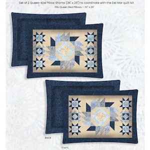 May include: Two queen-size pillow shams with a quilted design. Each pillow sham features a central geometric pattern in shades of blue, beige, and light blue, framed by a dark blue border. The shams measure 36" x 26" and fit queen bed pillows.