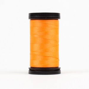May include: A spool of bright orange thread with black plastic caps on either end.