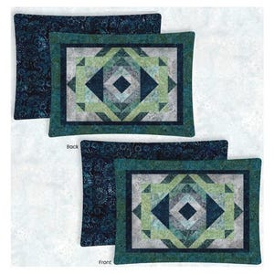 May include: Two pillowcases with a geometric pattern in shades of blue and green. The front pillowcase has a more intricate design with a central diamond shape. The back pillowcase has a simpler design with a floral pattern.
