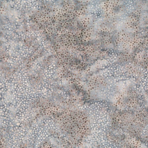 May include: A seamless fabric pattern featuring a mottled design with a mix of small, irregular dots in shades of brown, cream, and white against a muted blue-gray background. The pattern has a textured appearance.