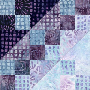 May include: A quilt block with a patchwork design featuring various shades of blue and purple. The block is made up of squares and triangles with different patterns, including dots, swirls, and geometric shapes.